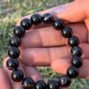 black obsidian 10mm natural gemstone bracelet in palm