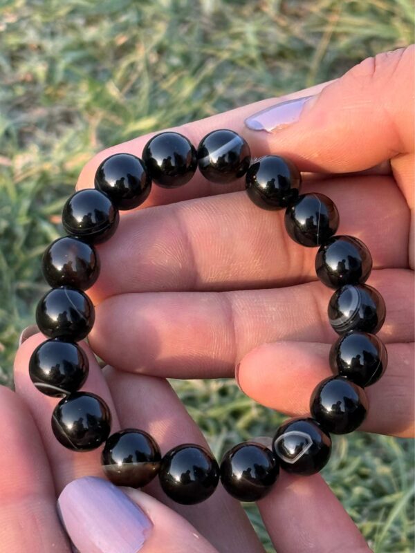 black obsidian 10mm natural gemstone bracelet in palm