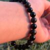 black obsidian natural gemstone bracelet in left hand