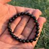 black obsidian natural gemstone bracelet in palm