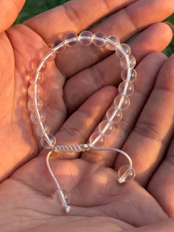 clear quartz natural gemstone bracelet in palm