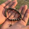 gold obsidian natural gemstone bracelet in hand