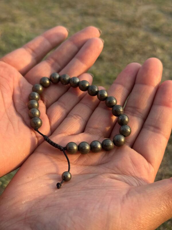 gold obsidian natural gemstone bracelet in hand