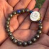 gold obsidian natural gem stone bracelet with guru bead in both palm