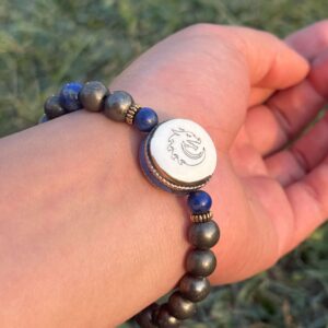 gold obsidian natural gem stone bracelet with guru bead in left hand