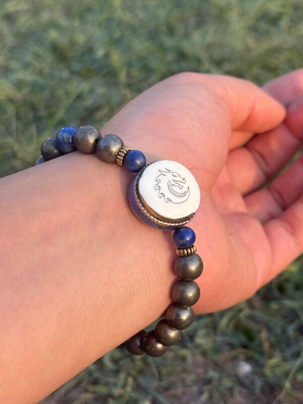 gold obsidian natural gem stone bracelet with guru bead in left hand