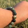 indian agate natural gemstone bracelet in left hand