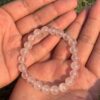 light rose quartz natural gem stone bracelet in palm