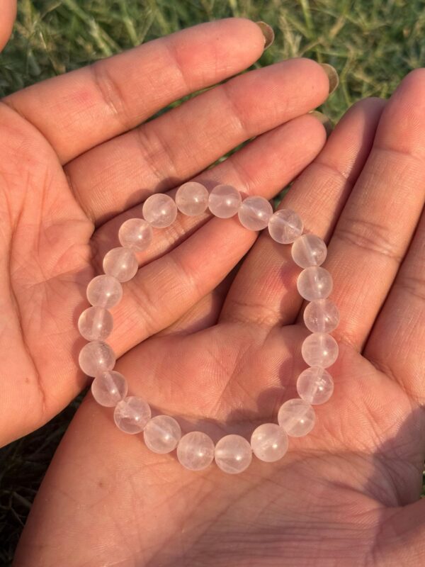 light rose quartz natural gem stone bracelet in palm