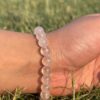 light rose quartz natural gem stone bracelet in left hand