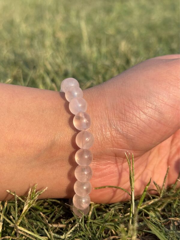light rose quartz natural gem stone bracelet in left hand