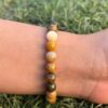 mookaite jasper natural gemstone bracelet in left hand