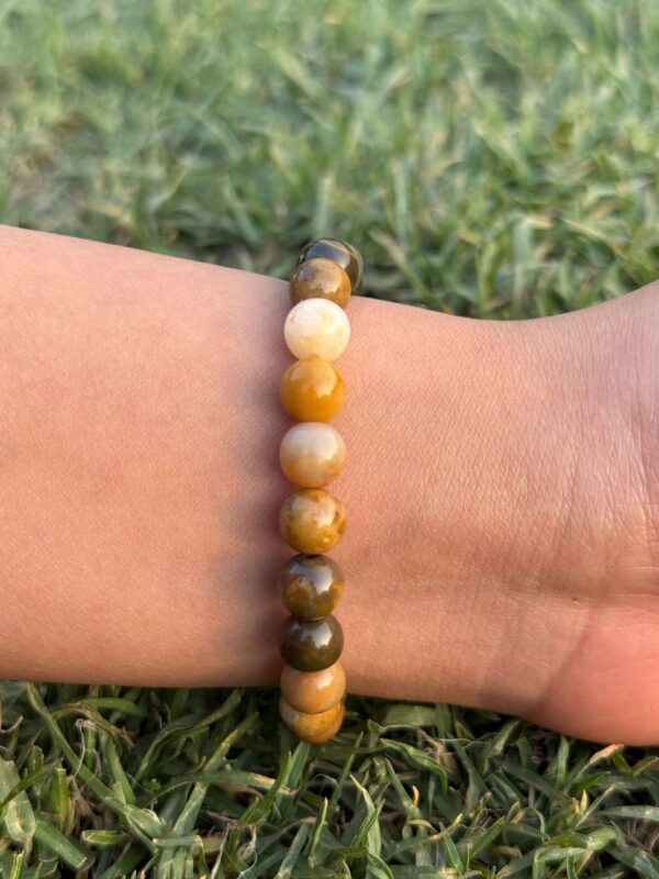 mookaite jasper natural gemstone bracelet in left hand