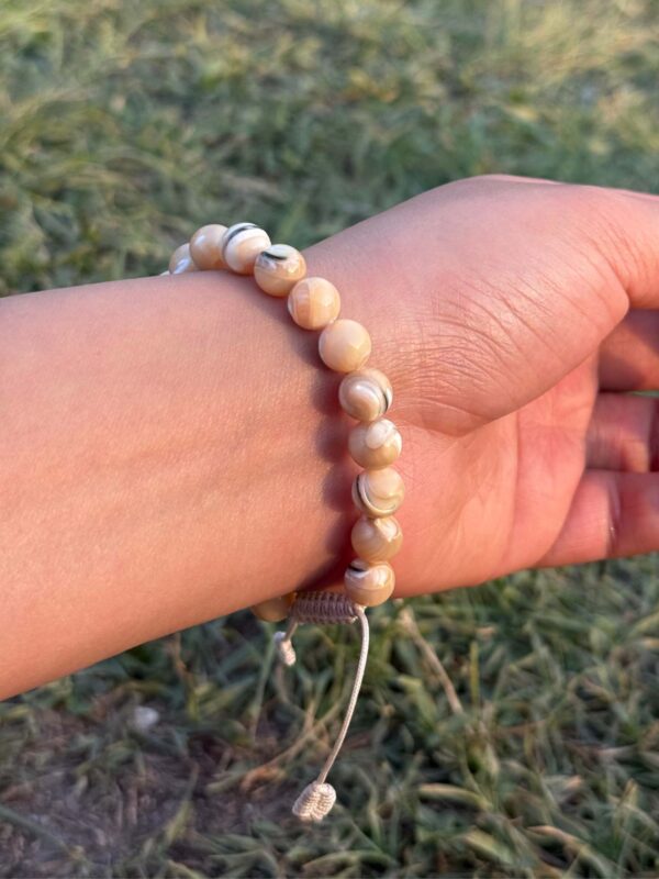 mother of pearl natural gemstone bracelet in hand