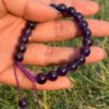 purple agate natural gem stone bracelet in hand side view