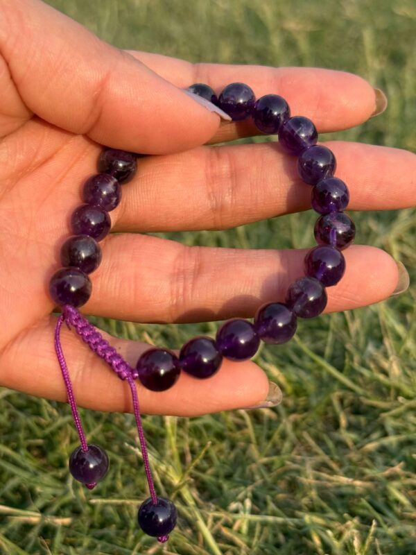 purple agate natural gem stone bracelet in hand side view