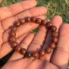 red jasper natural gem stone bracelet in palm