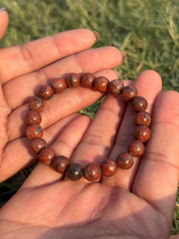red jasper natural gem stone bracelet in palm