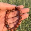 red jasper natural gem stone bracelet in left hand