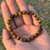 tiger eye natural gemstone bracelet tope view in palm