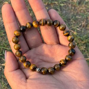 tiger eye natural gemstone bracelet tope view in palm