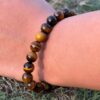 tiger eye natural gemstone bracelet in left hand