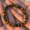 tiger eye natural gemstone bracelet in palm