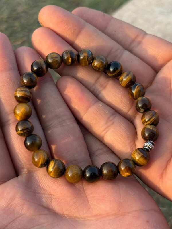 tiger eye natural gemstone bracelet in palm