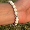 white howlite natural gemstone bracelet in left hand