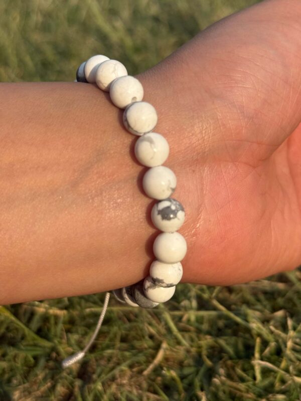 white howlite natural gemstone bracelet in left hand