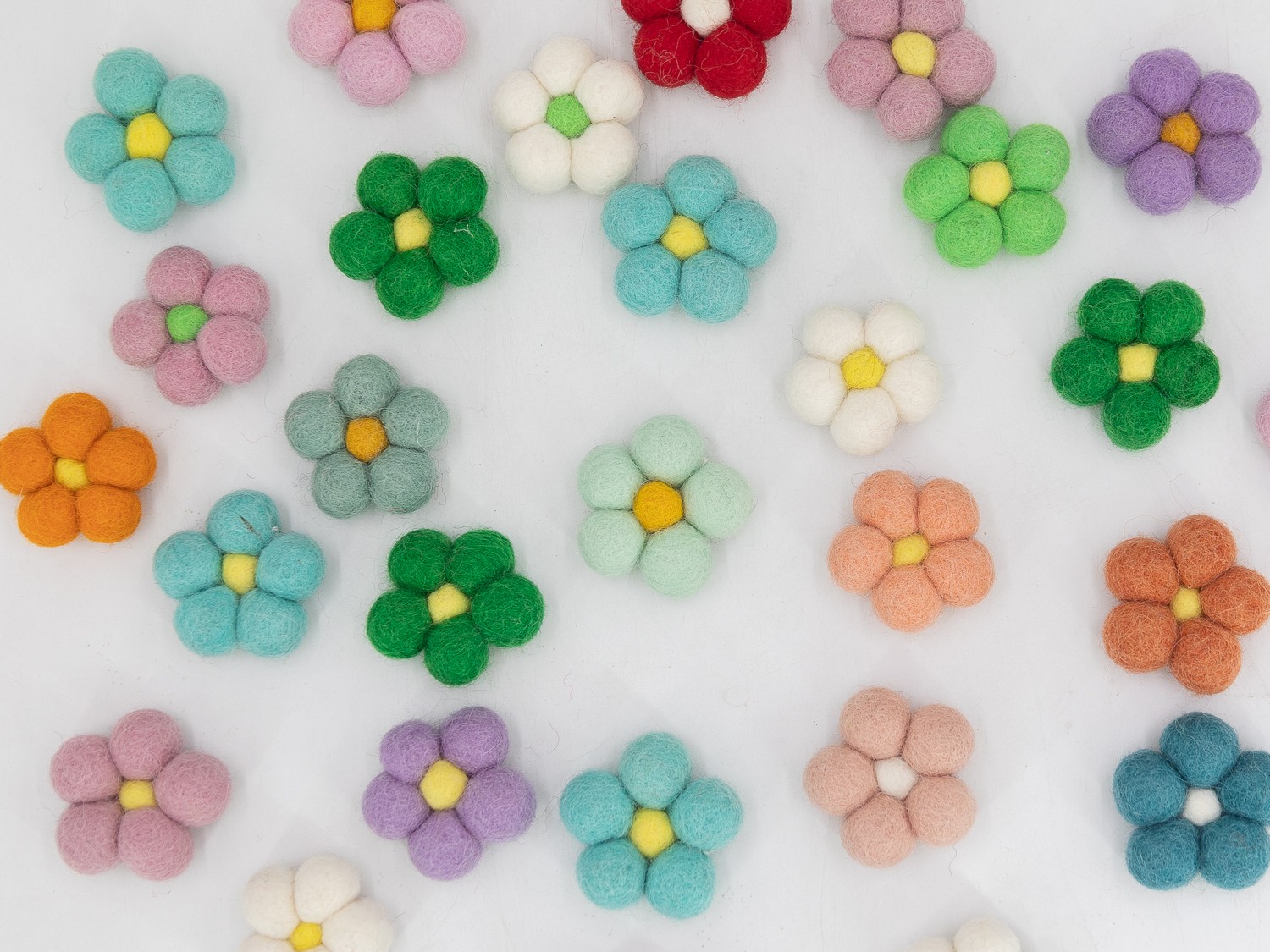 Colorful felt balls arranged for a handmade DIY craft project